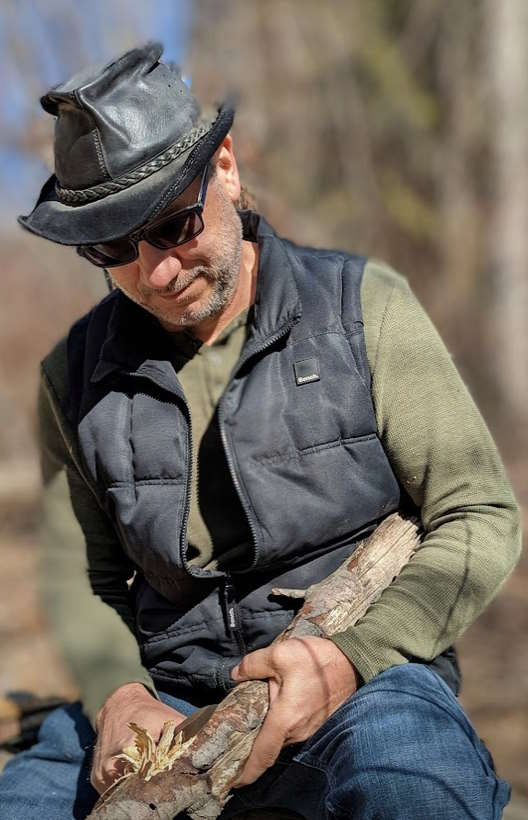 clayton-kessler-making-tinder Darryl Thompson. In the Okanagan sitting by Mission Creek getting ready to light a fire.